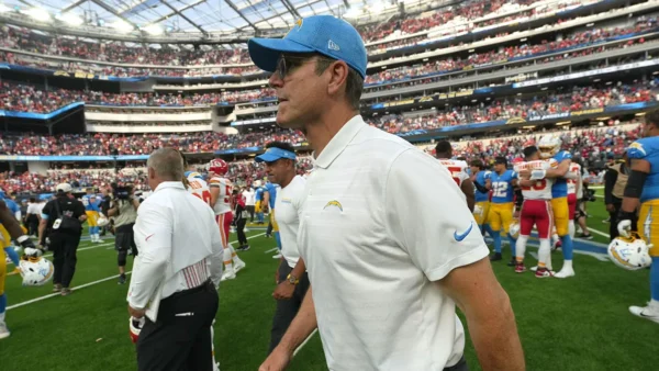 Jim Harbaugh of the Chargers leaves the game against the Broncos for a short while due to illness